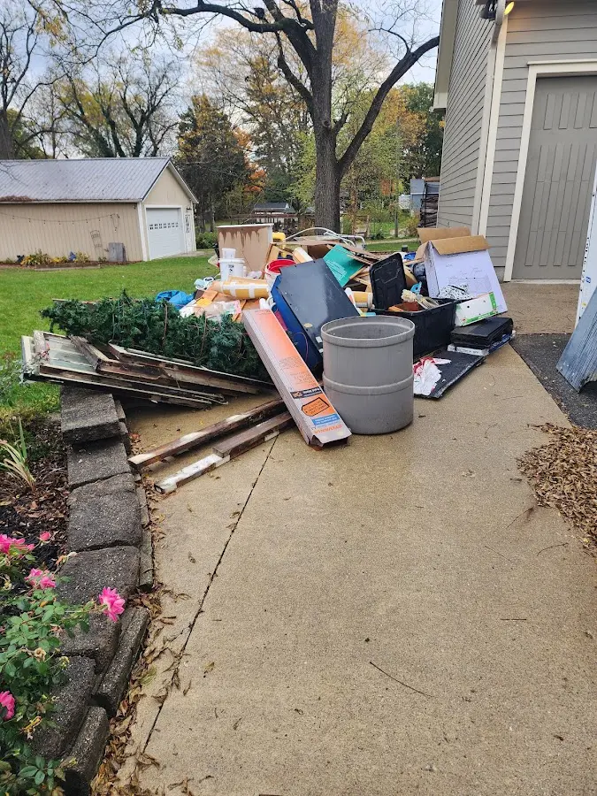 Dumpster being loaded with debris for Estate Cleanout Dumpster Rental in Simpsonville